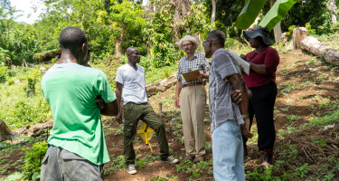 Irrigation Consultant Ministry of Agriculture officers in discussion with farmer Andell Daniel