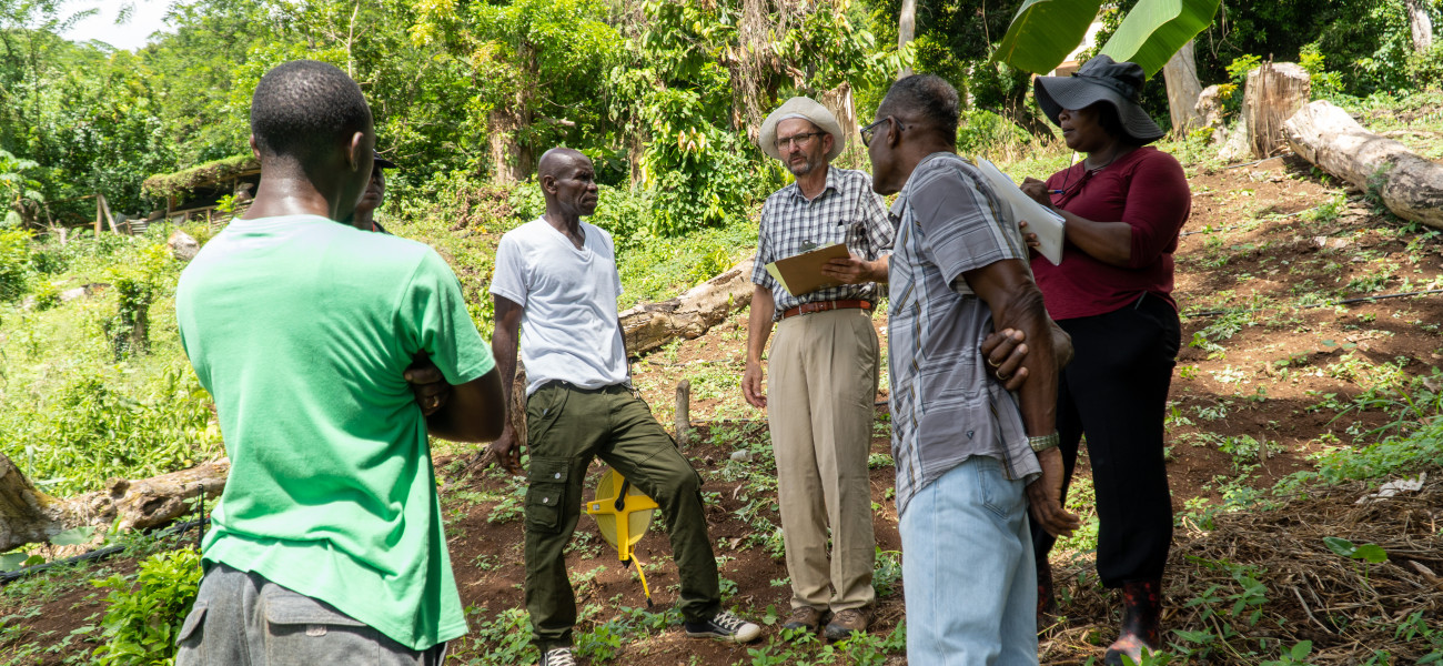 Irrigation Consultant Ministry of Agriculture officers in discussion with farmer Andell Daniel